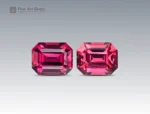 3.45 carat rhodolite garnet pair in emerald cut from Africa, deep pinkish-red faceted gems on neutral background