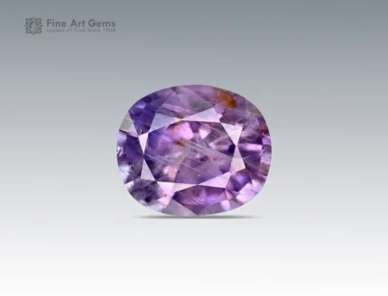 1.7 carat sapphire gemstone with oval cut from Nigeria, showing purple hues with natural inclusions, ideal for jewelry and collections