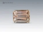 11 carat champagne topaz gemstone in emerald cut from Pakistan, rectangular faceted gem with natural inclusions on a neutral background