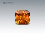 2.55 carat sphene (titanite) from Pakistan with asscher cut, glowing with golden-orange fire.
