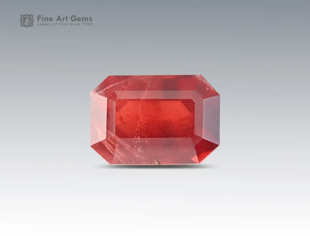 3.85 carat rhodolite garnet in emerald cut from Africa, deep red gemstone displayed on neutral background