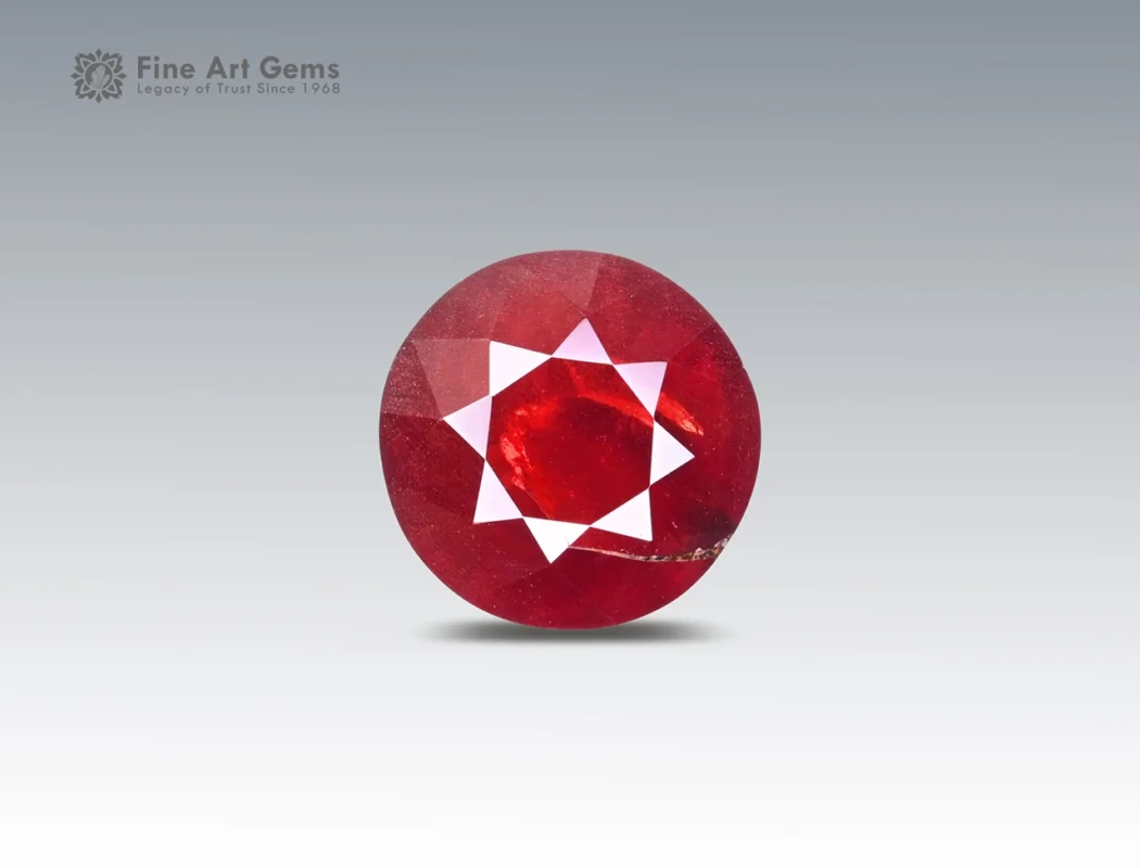 4.5 carat rhodolite garnet in round cut from Africa, vivid red faceted gemstone on neutral background