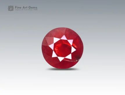 4.5 carat rhodolite garnet in round cut from Africa, vivid red faceted gemstone on neutral background