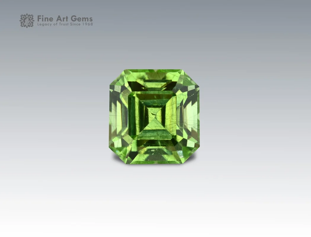 5.35 carat Pakistani peridot with Asscher cut, featuring fine ludwigite inclusions.