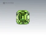 5.35 carat Pakistani peridot with Asscher cut, featuring fine ludwigite inclusions.
