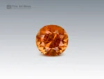 ound cut 50 cent clinohumite gemstone in vivid orange hue from Tajikistan