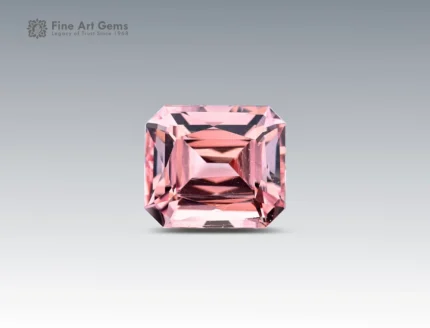 6.15 carat pink morganite gemstone in scissors cut from Nigeria, faceted rectangular gem on neutral background
