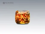 7.6 carat sphene (titanite) gemstone from Pakistan with cushion cut, showing golden-orange brilliance and fire.