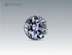 A 0.9 carat round-cut Parti Sapphire from Nigeria with sparkling blue and violet tones, ideal for jewelry.