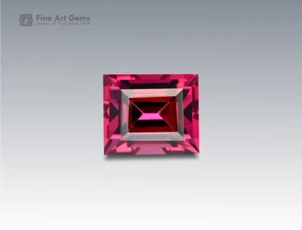 A 1.75 carat baguette-cut Rhodolite Garnet from Africa with vivid raspberry-red color, ideal for jewelry.