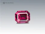 A 2.1 carat emerald-cut Rhodolite Garnet from Africa with deep raspberry-red brilliance, perfect for jewelry.