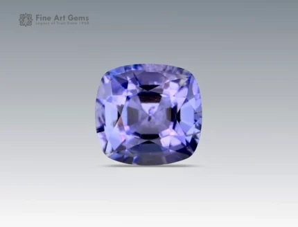 A 0.6 carat cushion-cut Parti Sapphire from Nigeria with vivid violet-blue tones, perfect for fine jewelry.