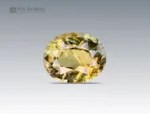 A 0.9 carat oval-cut Parti Sapphire from Nigeria with yellow-green tones, perfect for jewelry.