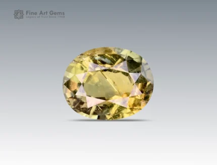 A 0.9 carat oval-cut Parti Sapphire from Nigeria with yellow-green tones, perfect for jewelry.