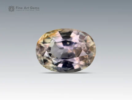 A 1.3 carat oval-cut Parti Sapphire from Nigeria showing mixed shades of green, yellow, and violet tones, ideal for jewelry.