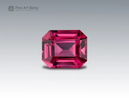 A 1.35 carat emerald-cut Rhodolite Garnet from Africa with rich raspberry-red color, ideal for fine jewelry.