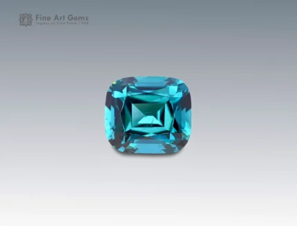 A 3 carat cushion-cut Indicolite Tourmaline from Afghanistan with vivid blue-green color and brilliance, perfect for jewelry.
