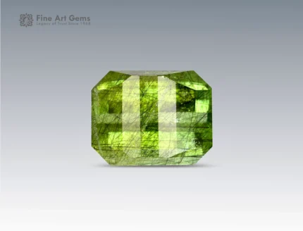 Brilliant 6 carat peridot gemstone from Pakistan featuring unique Ludwigite inclusions and a precise pixel cut, glowing with vibrant green tones.