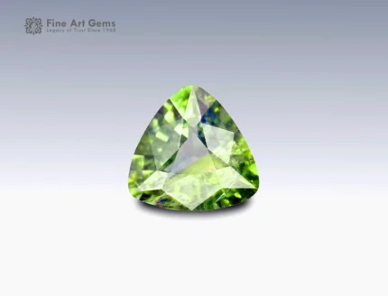 Trilliant-cut parti sapphire gemstone weighing 0.95 carats from Nigeria, displaying a mix of green and yellow hues with fine brilliance.