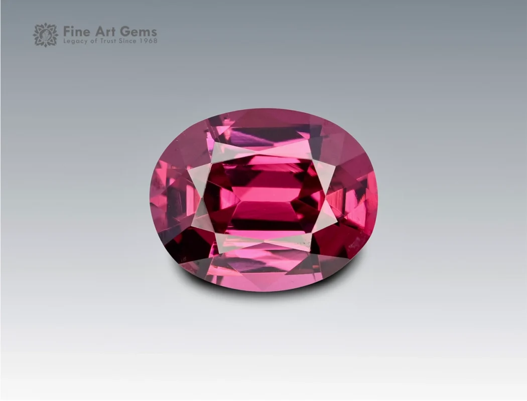 Brilliant 1.7 carat oval cut rhodolite garnet with vivid pinkish-red hue, sourced from Africa. Ideal for fine jewelry and gemstone collections.