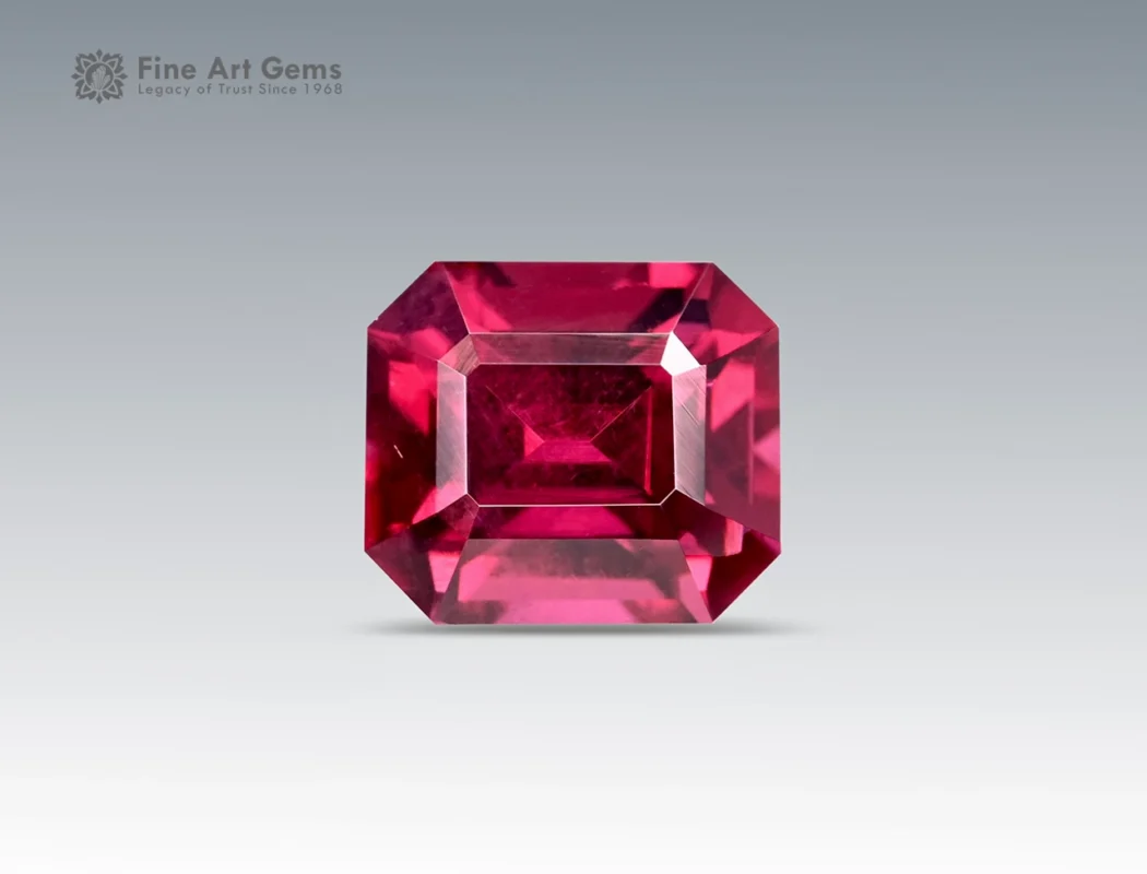 Emerald-cut deep purplish-pink rhodolite garnet weighing 1.70 carats from Africa, with vibrant saturation and fine clarity.