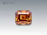 Brilliant 2-carat emerald cut sphene (titanite) gemstone with golden-orange brilliance, sourced from Pakistan. Rare and collectible gemstone for jewelry and gem enthusiasts.