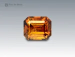 Natural 2.5 carat emerald cut sphene (titanite) gemstone from Pakistan with golden-orange brilliance and exceptional fire. Perfect for collectors and jewelry design.