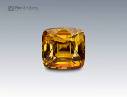 Natural 3 carat cushion cut sphene (titanite) gemstone from Pakistan with golden-green brilliance and exceptional fire. Rare and collectible.