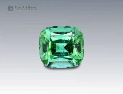 Cushion-cut green tourmaline gemstone weighing 3.25 carats from Afghanistan, displaying vivid saturation and fine clarity.