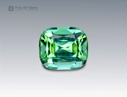 Cushion-cut green tourmaline gemstone weighing 2.25 carats from Afghanistan, with mixed green tones and fine brilliance.