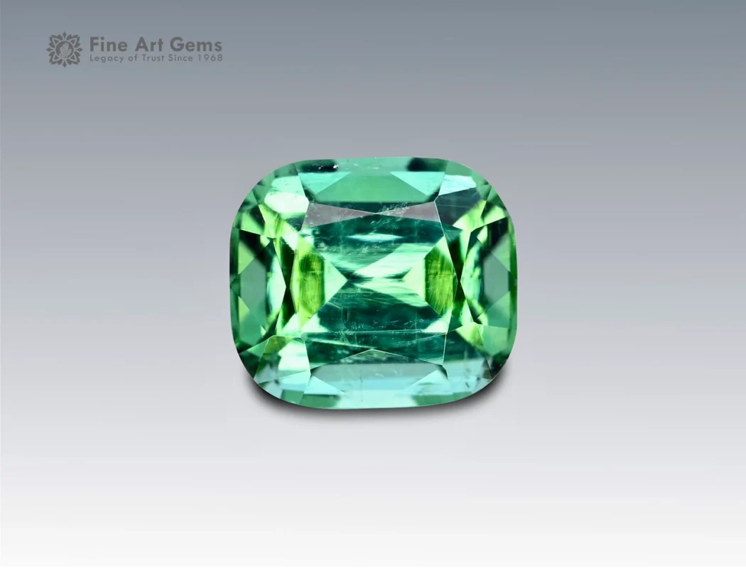 Cushion-cut green tourmaline gemstone weighing 2.25 carats from Afghanistan, with mixed green tones and fine brilliance.
