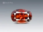 Oval-cut red bastnaesite gemstone from Pakistan.