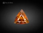 Brilliant 01-carat trillion-cut sphene (titanite) gemstone from Pakistan, showing vivid golden-orange fire, ideal for jewelry, rings, pendants, or gemstone collections.