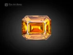 1.85 carat emerald cut sphene (titanite) gemstone from Pakistan, showing golden-orange color and brilliant sparkle