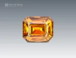 1.85 carat emerald cut sphene (titanite) gemstone from Pakistan, showing golden-orange color and brilliant sparkle
