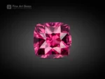 Cushion-cut rhodolite garnet gemstone from Africa with vivid rose-red color and excellent clarity.