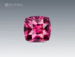 Cushion-cut rhodolite garnet gemstone from Africa with vivid rose-red color and excellent clarity.