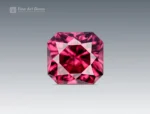 A 1-carat cushion-cut Rhodolite Garnet from Africa with a plum-pink tone, clear interior, and bright reflections from sharp faceting.