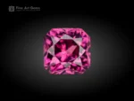 A 1.10-carat cushion-cut Rhodolite Garnet from Africa with a plum-pink tone, clear interior, and bright reflections from sharp faceting.