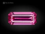 1.10 carat emerald cut rhodolite garnet gemstone with a bright pink-raspberry color.