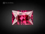 Emerald cut hot pink rhodolite garnet, 1.35 ct, eye clean clarity, photographed on a neutral background.