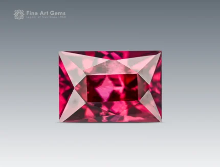 Emerald cut hot pink rhodolite garnet, 1.35 ct, eye clean clarity, photographed on a neutral background.