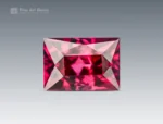 Emerald cut hot pink rhodolite garnet, 1.35 ct, eye clean clarity, photographed on a neutral background.