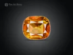 Faceted cushion-cut sphene gemstone showing golden-orange color and gemmy brilliance from Pakistan.