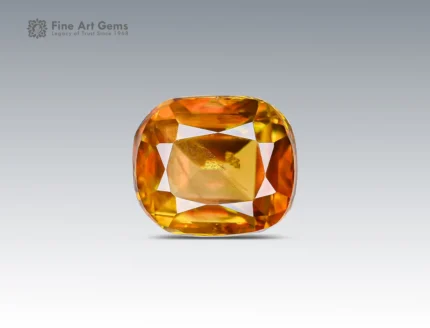 Faceted cushion-cut sphene gemstone showing golden-orange color and gemmy brilliance from Pakistan.