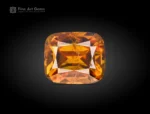 Faceted cushion-cut sphene gemstone showing golden-orange color and gemmy brilliance from Pakistan.