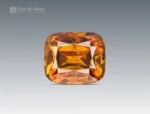 Faceted cushion-cut sphene gemstone showing golden-orange color and gemmy brilliance from Pakistan.