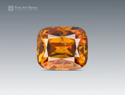 Faceted cushion-cut sphene gemstone showing golden-orange color and gemmy brilliance from Pakistan.