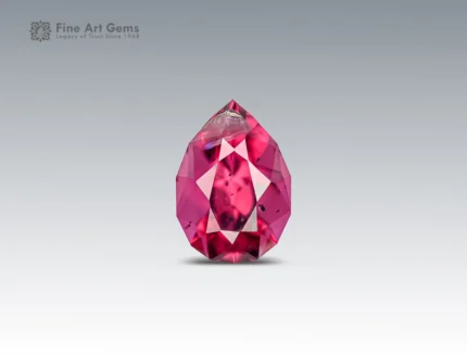 Pear-cut rhodolite garnet gemstone with vivid raspberry color and clean faceting from Africa.