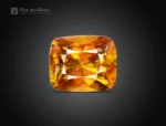 Faceted cushion-cut sphene gemstone showing golden-orange color and gemmy brilliance from Pakistan.